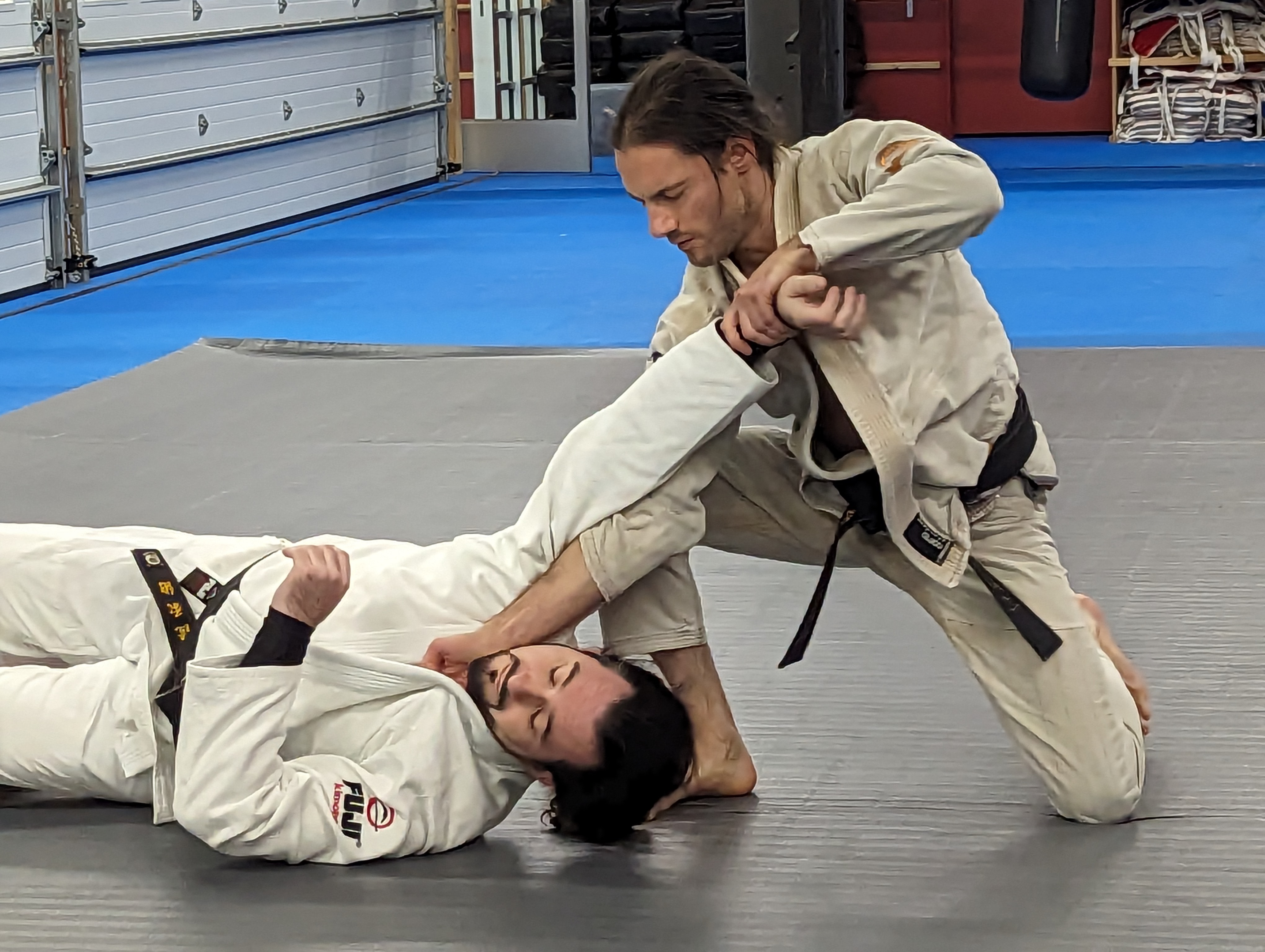 Andrew Ilardi applying a technique on the mat